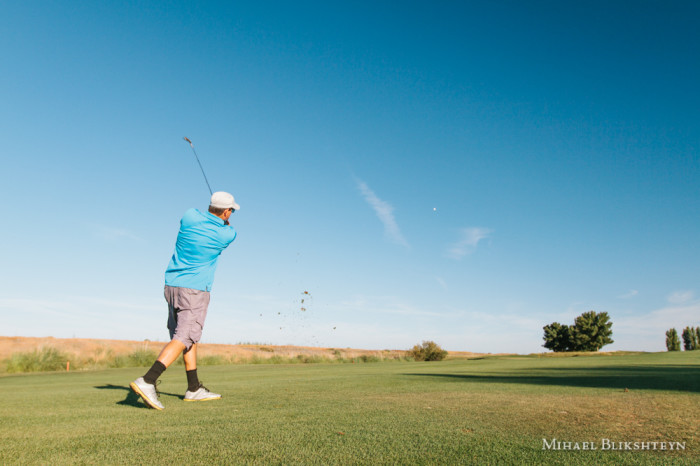 Man playing golf on a sunny day on a beautiful golf course