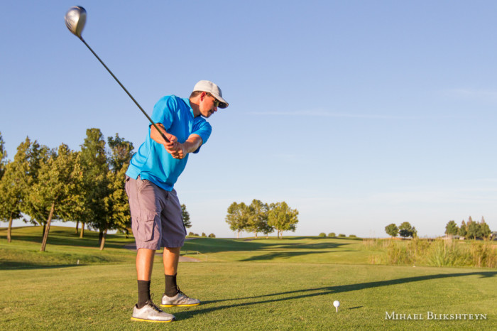 Man playing golf on a sunny day on a beautiful golf course