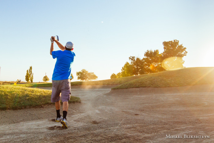 Man playing golf on a sunny day on a beautiful golf course