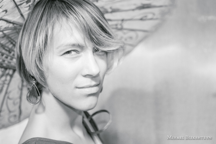 Black and white photo of a young woman with an exquite sun umbrella