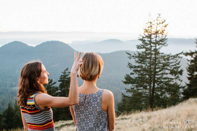 Two young women watching sunset