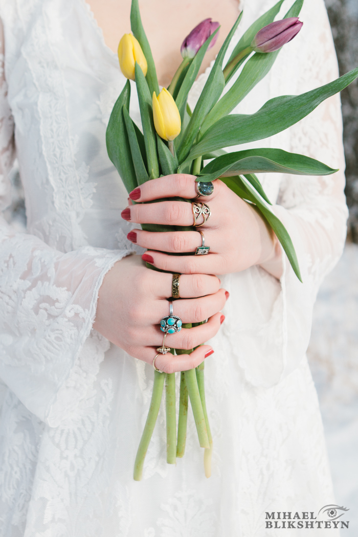 Closeup of a young woman's hands holding a bouquet of flowers ou